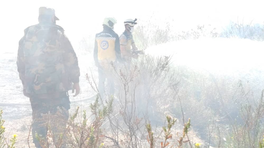 Controlling a fire in Kafr Laha before extending it to the olive trees