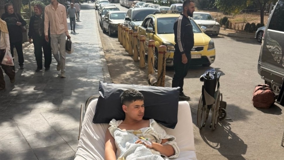 A patient is left in front of Mouwasat Hospital after being refused to receive him