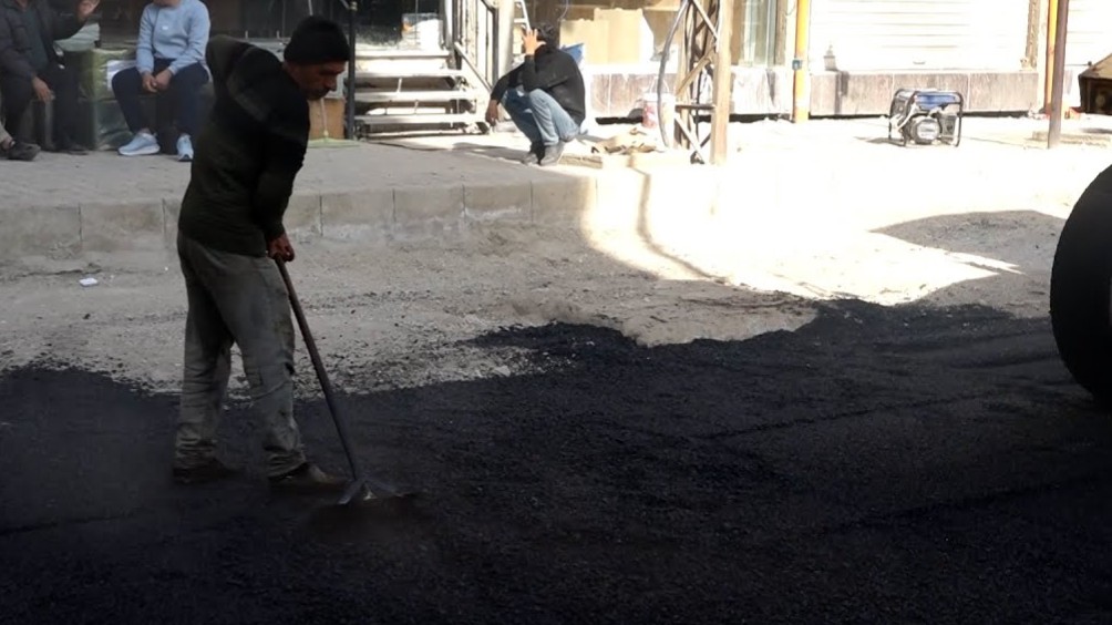 بلدية الشعب بالحسكة تزيل الحجر البازلتي وتعيد تعبيد شارع المفتي بالزفت