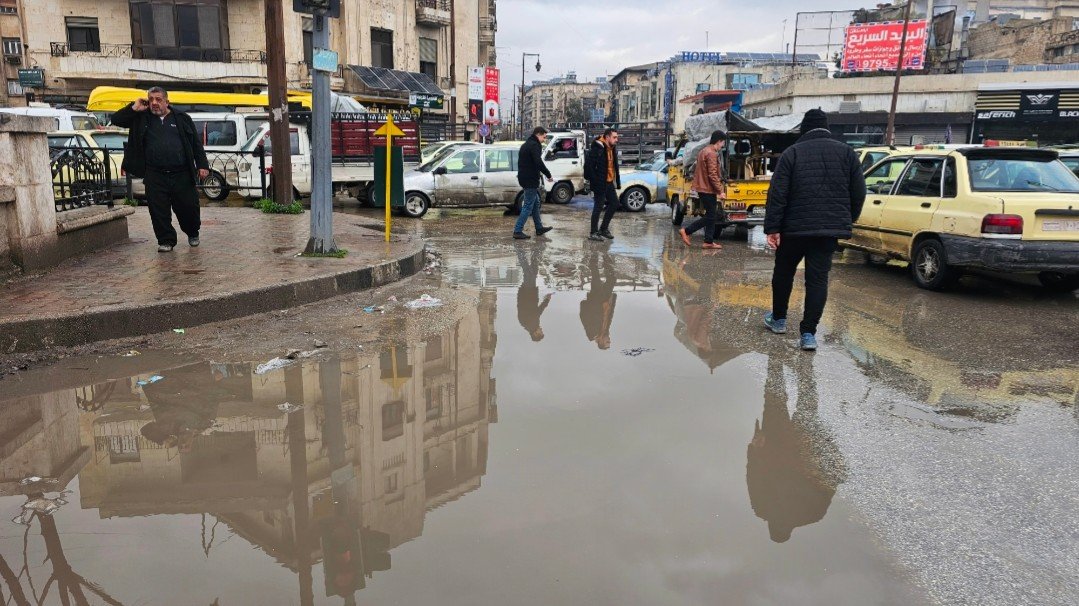 The flooded streets of Aleppo provide an opportunity to wade through the mud for citizens